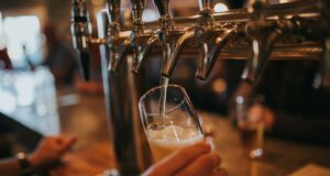 person filling beer on glass
