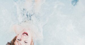 high-angle of kid playing with water