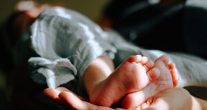 person holding baby feet