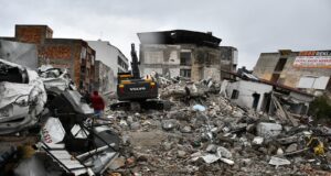 a large pile of rubble next to a building