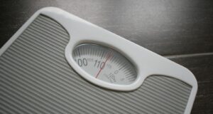 a bathroom scale sitting on top of a wooden table