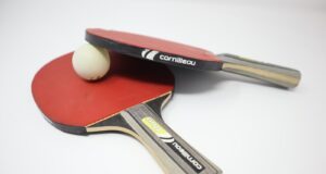 two red pingpong rackets on white surface