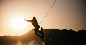 person wake boarding on body of water