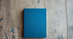 blue book on brown wooden board