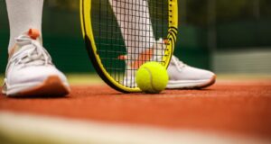 person in white nike sneakers playing tennis