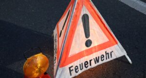 a warning sign sitting on the side of a road
