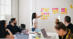 woman placing sticky notes on wall