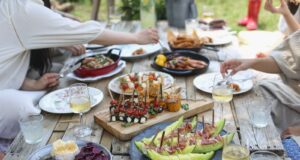 group of people eating on backyard