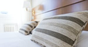 gray and black throw pillow on bed