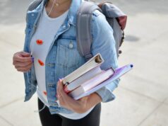 Saarland führt landesweite Medienausleihe an allen weiterführenden Schulen ein woman wearing blue denim jacket holding book