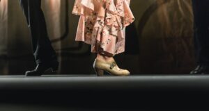 two man and woman standing back to back