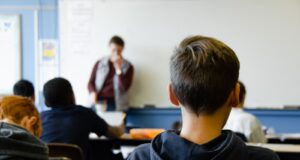 boy in black hoodie sitting on chair