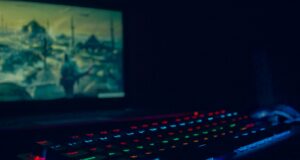 black laptop computer turned on with blue lights