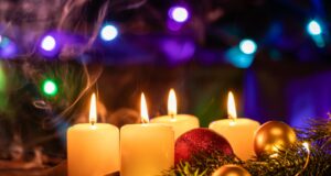 white candles on brown wooden table