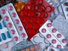 pile of blister packs of colorful medicine tablets