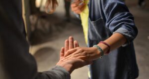 man and woman holding hands on street