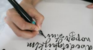 person writing on white paper