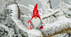 snowman wearing red hat and white scarf