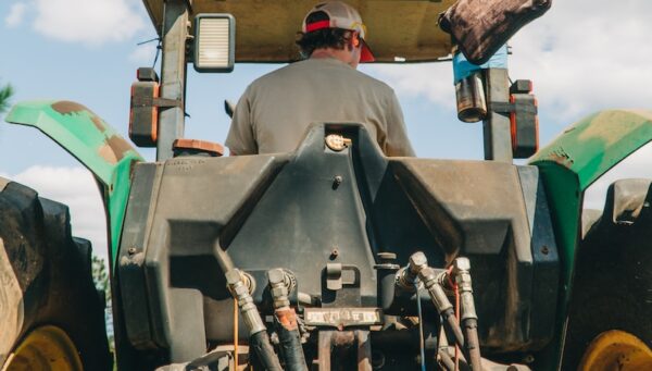 man riding tractor