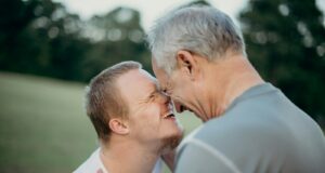 two man talking to each other on grass field