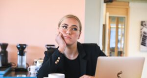 woman in black long sleeve shirt using macbook