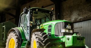 green and yellow tractor in garage