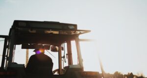 silhouette of man riding tractor