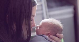 woman kissing baby