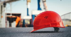red hard hat on pavement