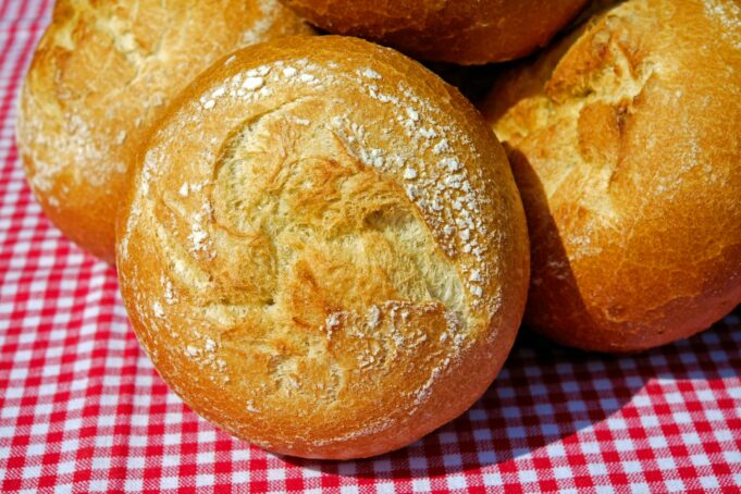 bread on red and white checkered textile