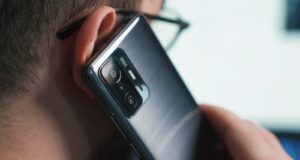 a close up of a person talking on a cell phone