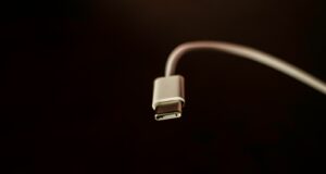 white usb cable on black surface