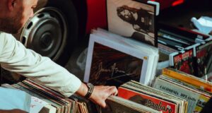 person holding vinyl records