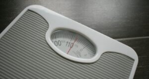a bathroom scale sitting on top of a wooden table