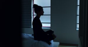 woman sitting on bed