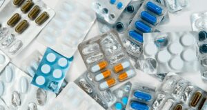 a pile of pills sitting next to each other on top of a table