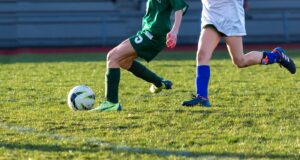 a couple of kids playing a game of soccer