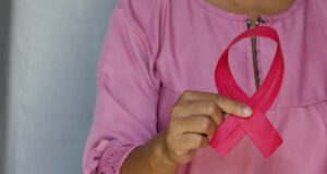 woman in pink and white polka dot shirt