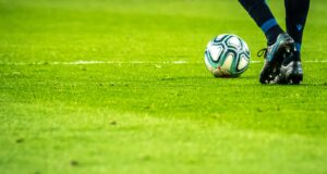 man playing soccer game on field