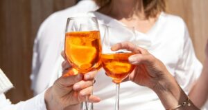 a couple of people that are holding some wine glasses