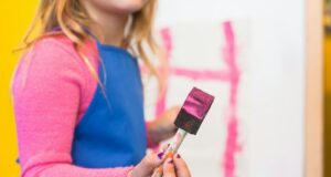 girl using pink paint brush