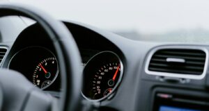 black vehicle dashboard with speedometer on 100