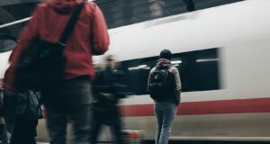 people standing beside train