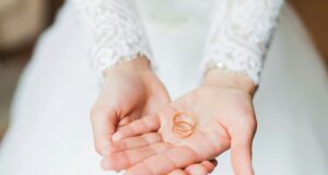 person holding copper rings during daytime