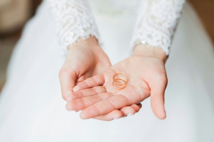 person holding copper rings during daytime