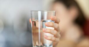 person holding clear drinking glass