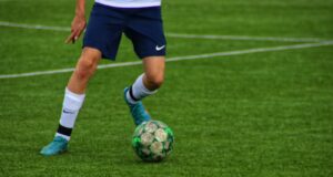 a football player kicking a ball