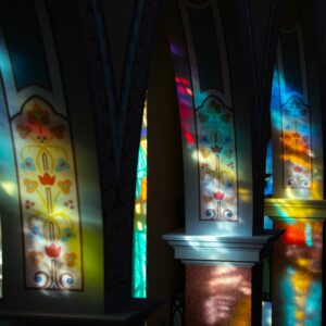 a row of stained glass windows in a church