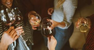 group of people tossing wine glass