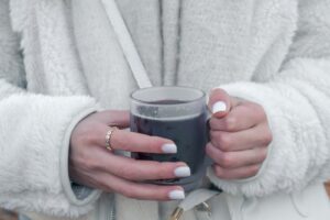 a woman holding a glass of wine in her hands